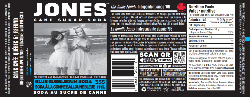 A Blue Bubblegum Jones Soda label featuring my photo of my friends Brandy (right) and Ashley (left) wearing creepy masks and lingerie while standing on a moody beach with their backs toward the water. Brandy is holding a small plastic skeleton bear in her hands. The entire label is in black and white, including the photo, except the "Blue Bubblegum Soda 355mL" part in english and french, which is electric blue.