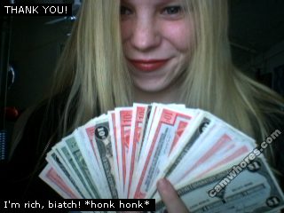 A 320x240 pixel resolution webcam photo of Sunny Crittenden holding up a w fanned out wad of Canadian Tire money that was sent in and donated by fans for a gardening project called "Keep Off The Lawn". The caption reads "I'm rich, biatch! "honk honk*"