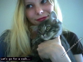 A 320x240 pixel webcam photo of Sunny Crittenden circa 2005. She is holding a grey cat.